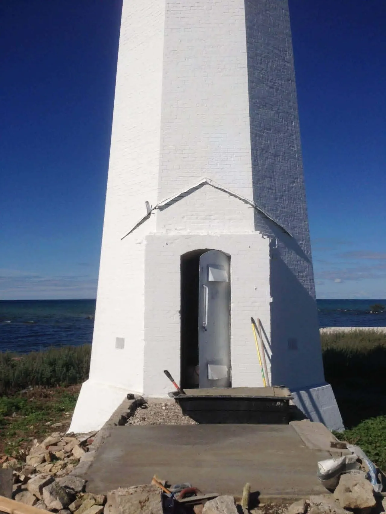 The entrance door at the foot of Skillagalee's tower with fresh concrete steps.