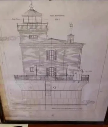 A framed architectural drawing of the lighthouse showing its base and house in elevation.